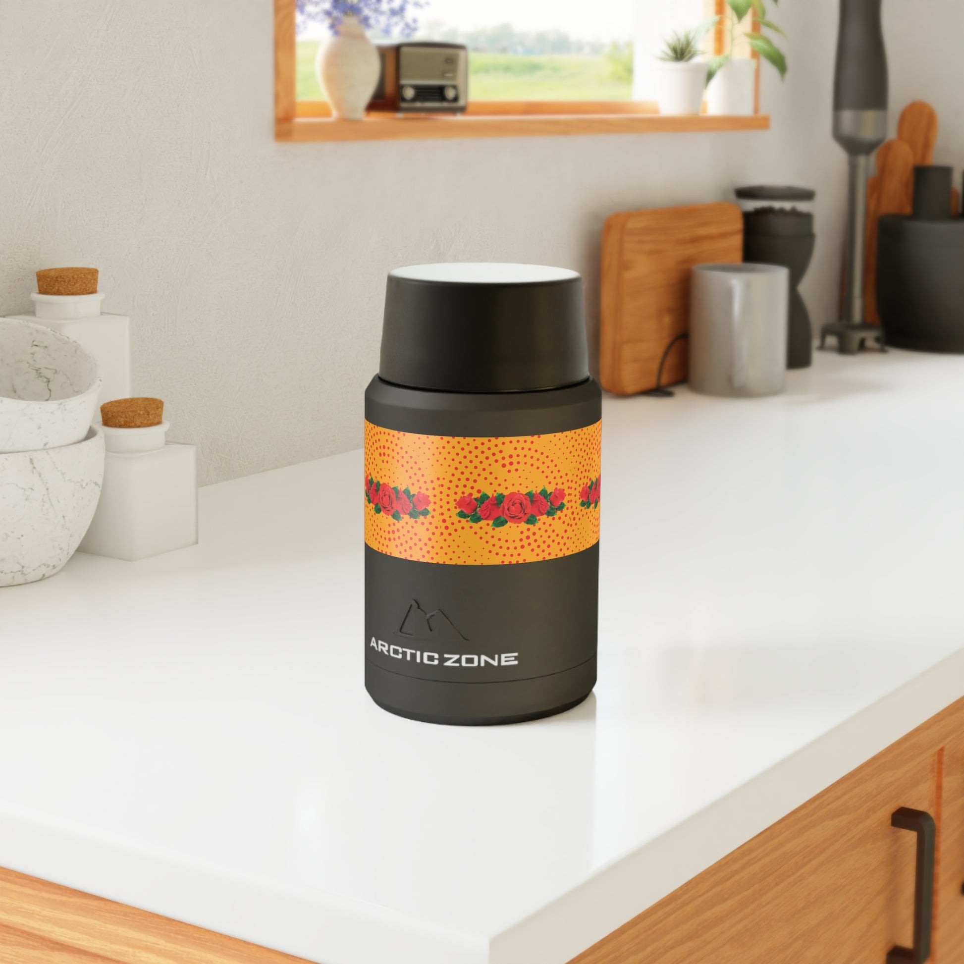 Black and orange insulated food jar on a kitchen counter with 'Arctic Zone' branding.