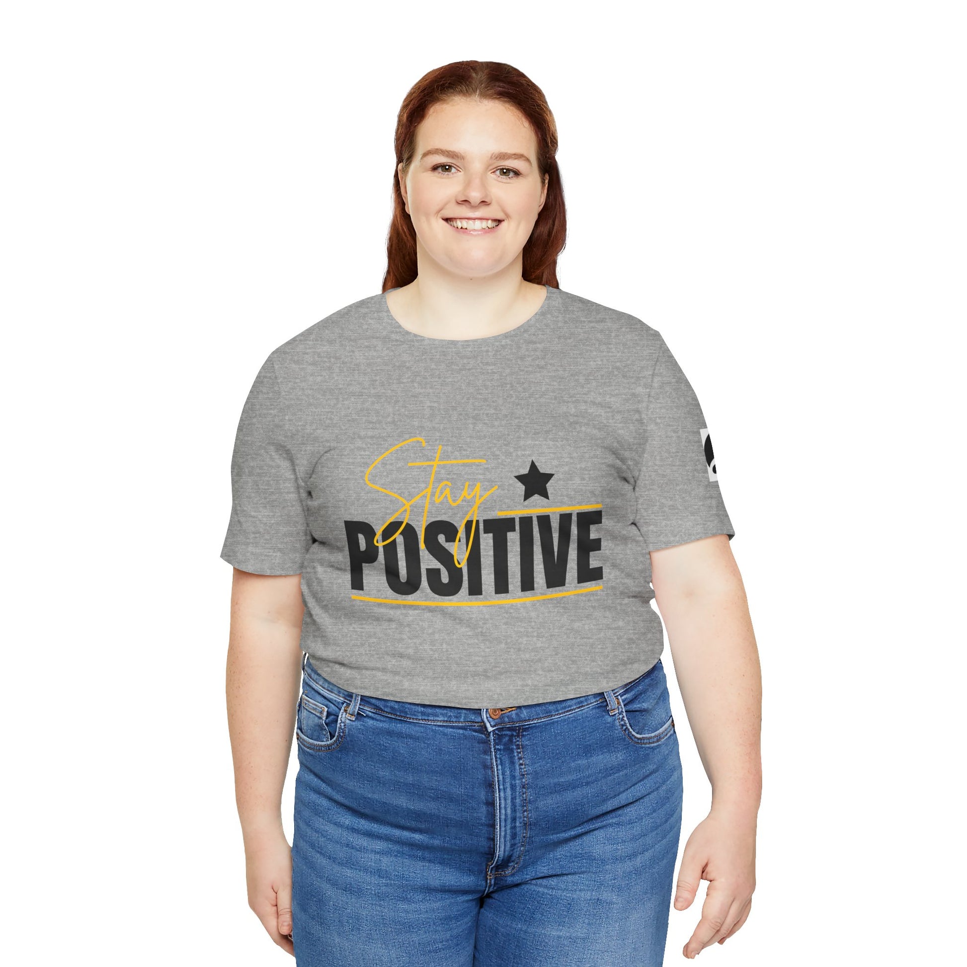 Person wearing a gray t-shirt with 'Stay Positive' text on a white background