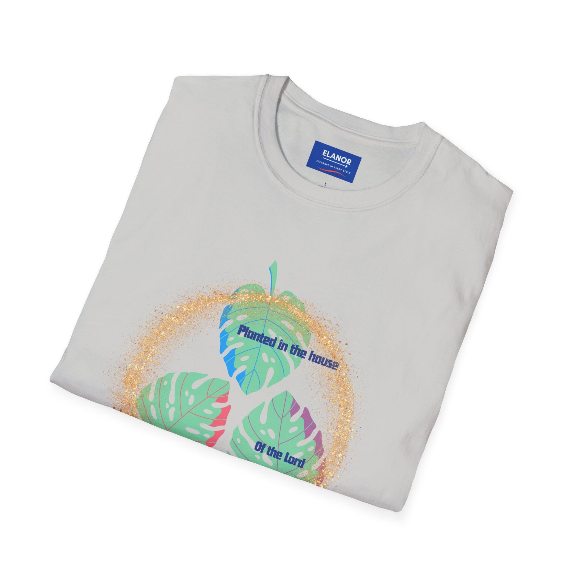 Folded t-shirt with tropical leaf design and text on a white background