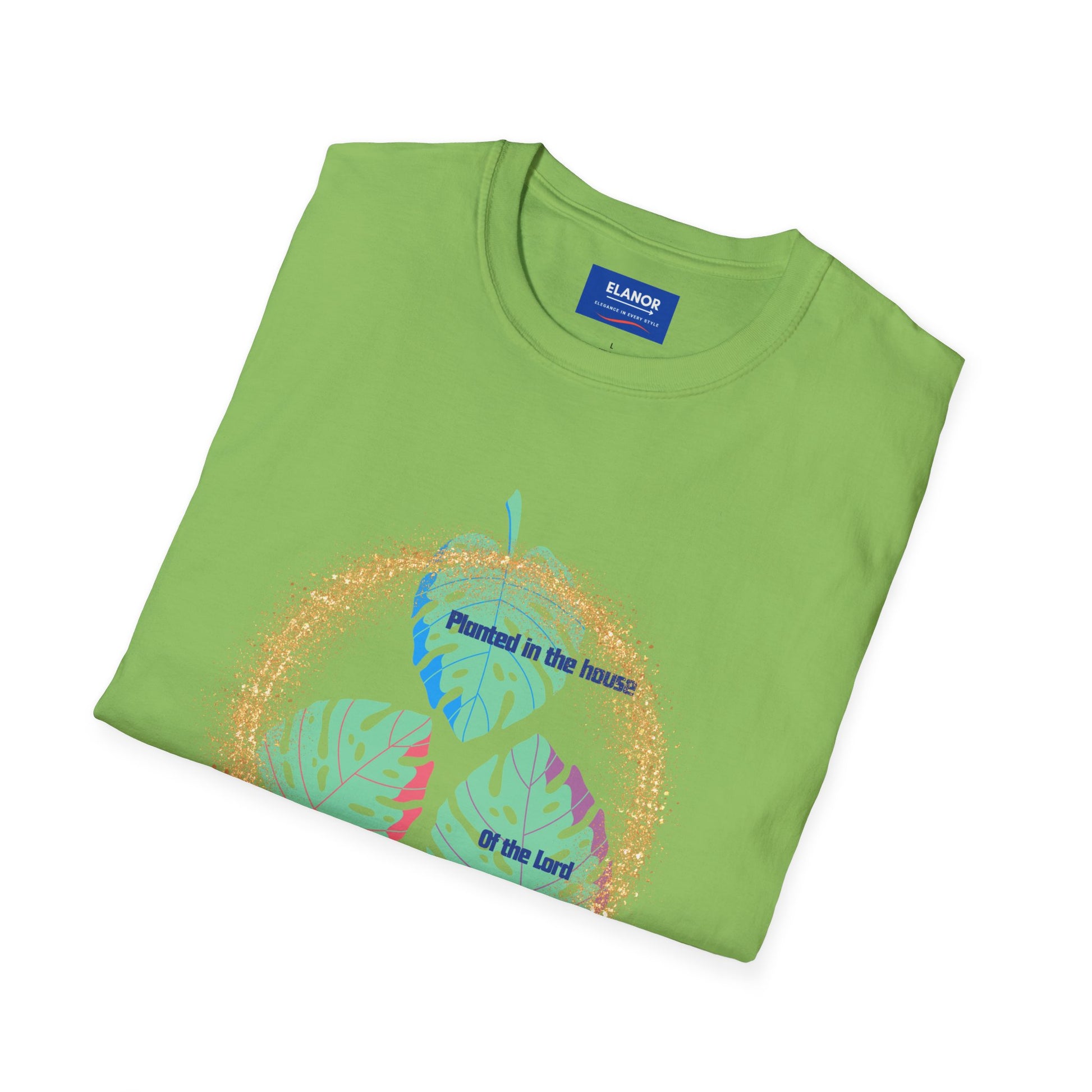 Folded green t-shirt with a colorful graphic and 'Emanuel' label on a white background