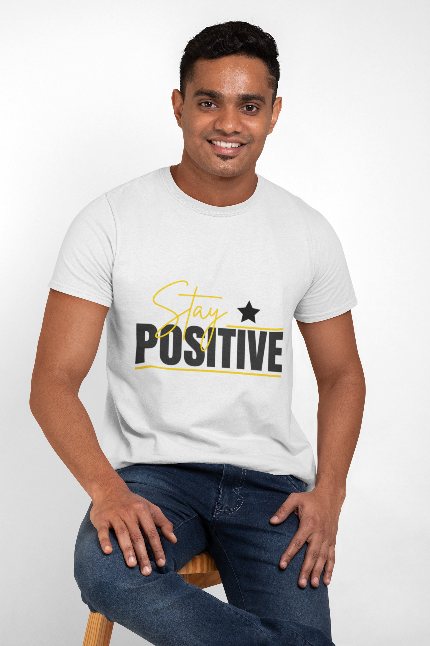 Man wearing a white t-shirt with 'Stay Positive' text on a white background
