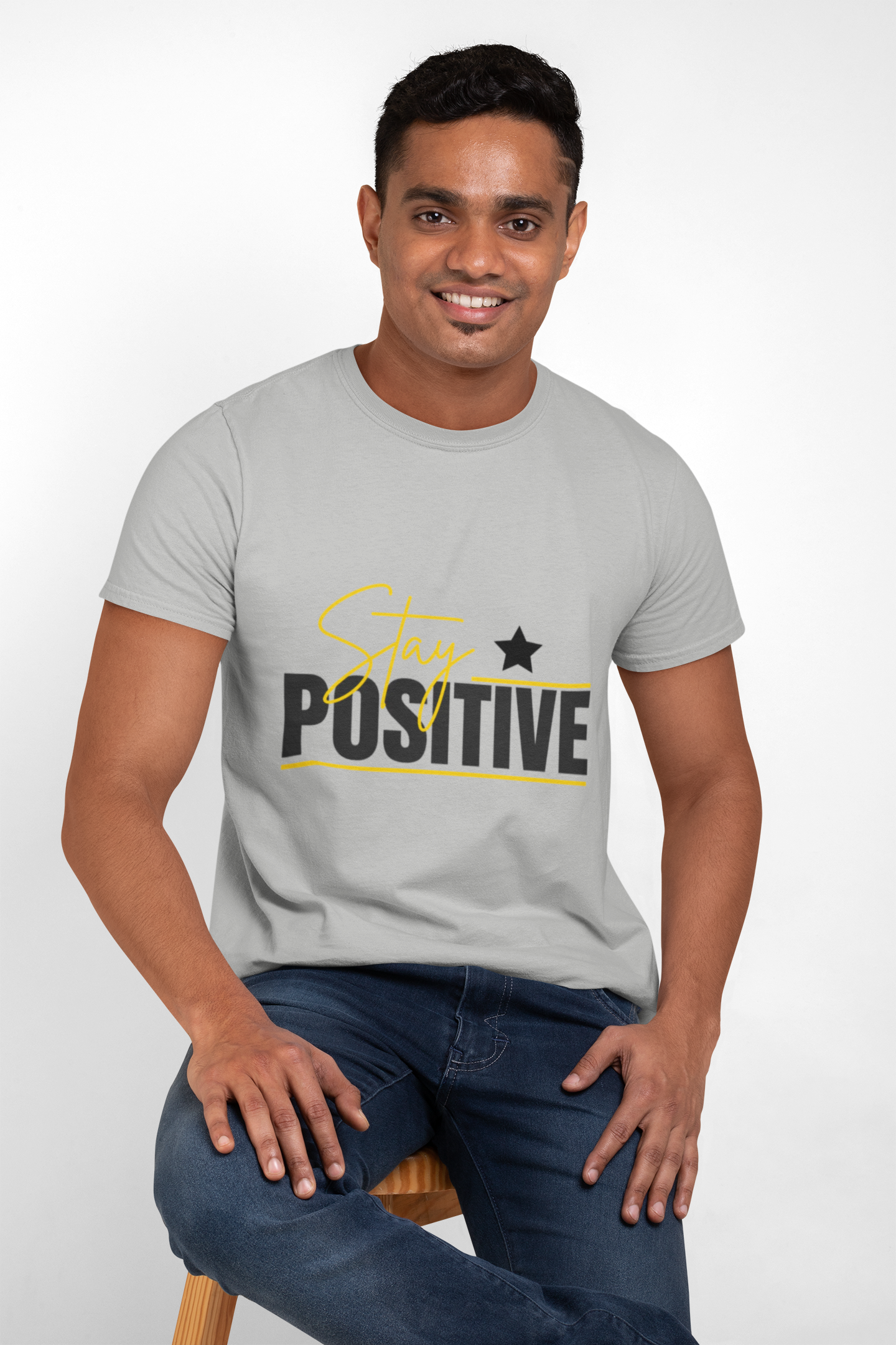 Man wearing a gray t-shirt with 'Stay Positive' text on a white background
