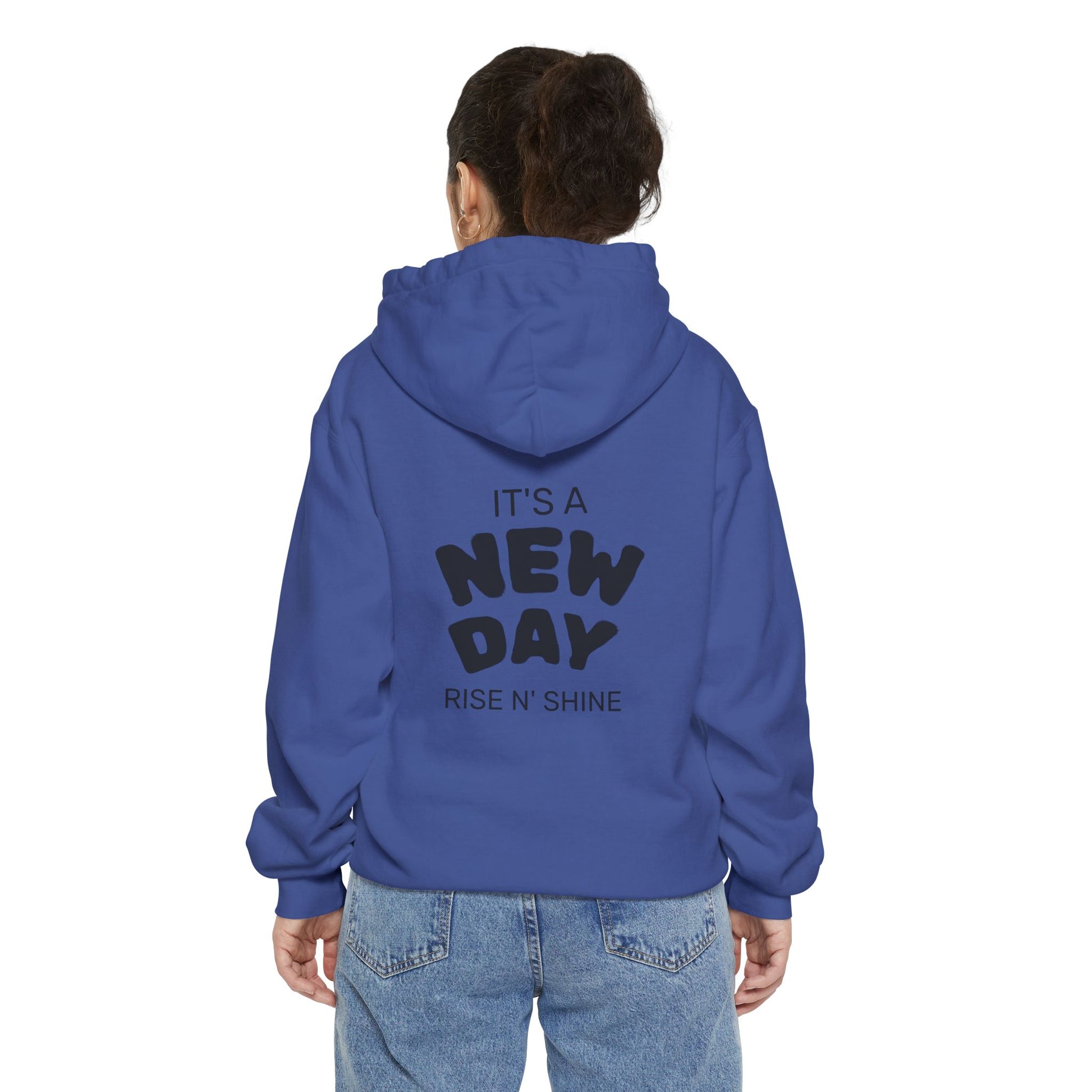 Person wearing a blue hoodie with text on the back, standing against a white background