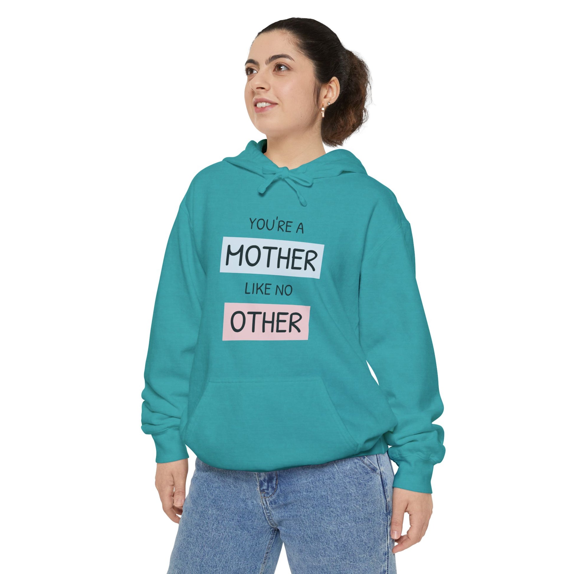 Person wearing a teal hoodie with text on a white background