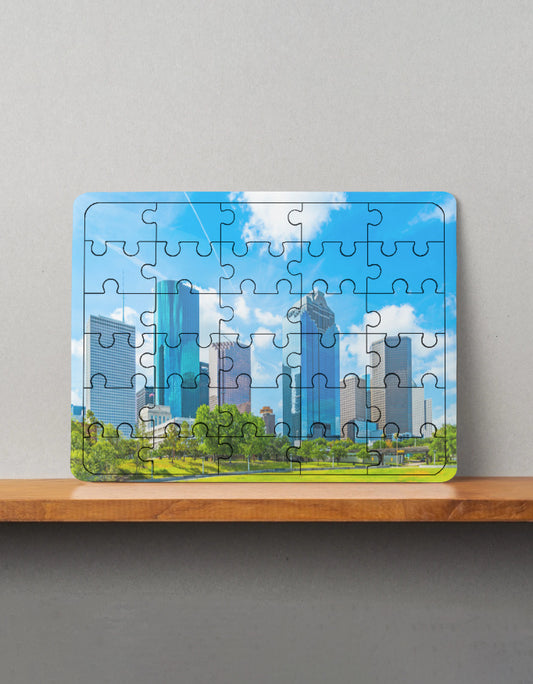 Jigsaw puzzle of a cityscape on a wooden shelf with a gray background