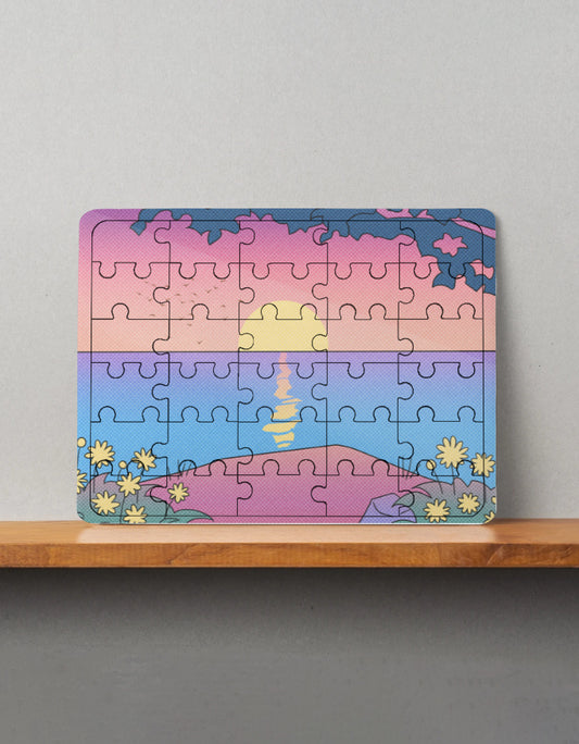 Colorful puzzle with a sunset design on a wooden shelf against a gray wall.
